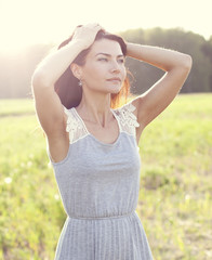 Woman in a dress standing in a field
