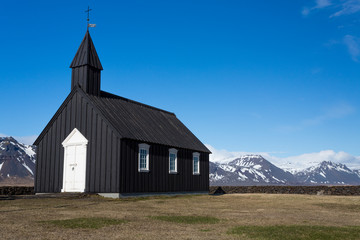 Fototapeta na wymiar Black Wooden church and mountains