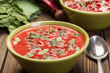 Beetroot soup with fresh vegetables in a bowl
