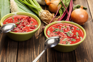 Beetroot soup with fresh vegetables in a bowl
