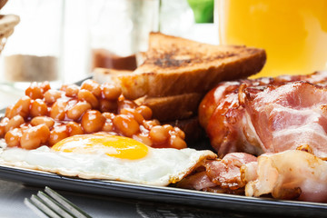 Full English breakfast with bacon, sausage, egg and baked beans