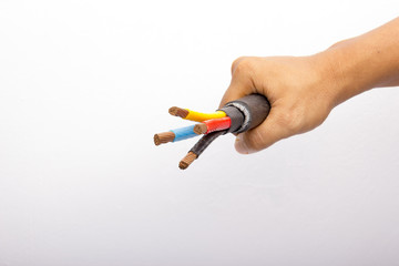 hand holding a three-phase voltage electricity cable