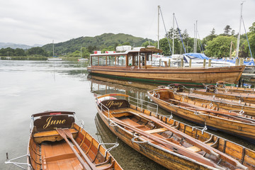 Fototapeta na wymiar Wooden rowing boats and lake cruise boat, Waterhead, Ambleside