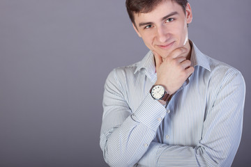 Young businessman in a shirt with a clock