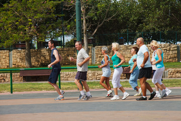 Active Mature People with fitness Trainer