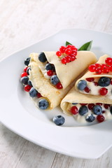 Pancakes with cream and fresh blueberries