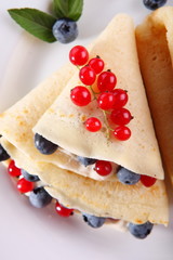 Pancakes with cream and fresh blueberries