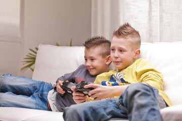 two kids playing video games © Giulio_Fornasar