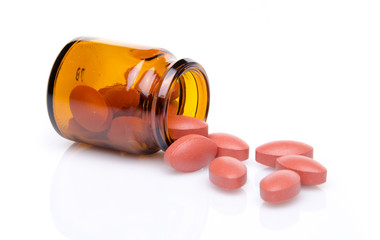 Pills spilling out of pill bottle