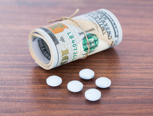 Banknotes By Pills On Table