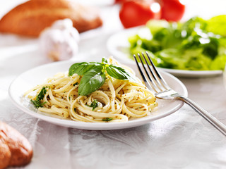 plate of italian spaghetti with pesto sauce