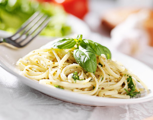 plate of italian spaghetti with pesto sauce