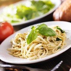 plate of italian spaghetti with pesto sauce
