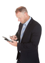 Businessman Using Calculator