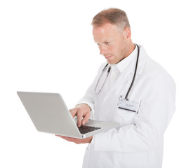 Doctor Using Laptop Over White Background