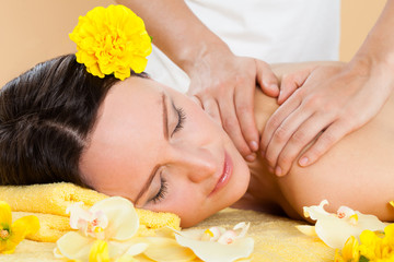 Obraz na płótnie Canvas Smiling Woman Receiving Shoulder Massaging In Spa