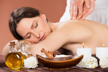 Fototapeta na wymiar Woman Receiving Back Massaging In Spa