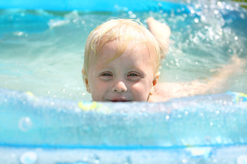 Fototapeta na wymiar Happy Baby Playing in Swimming Pool