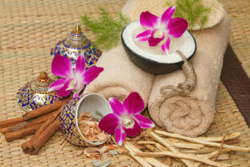 Fototapeta na wymiar Thai spa massage setting with spa essential oil , towel, herb ,