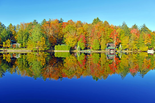 Autumn colors reflection in lake, Adirondacks, New York