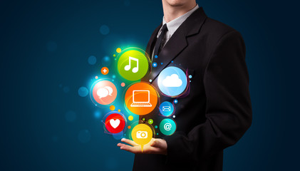 Young businessman presenting colorful technology icons and symbo