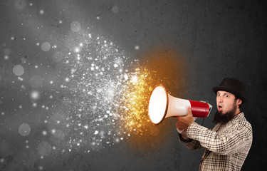 Guy shouting into megaphone and glowing energy particles explode