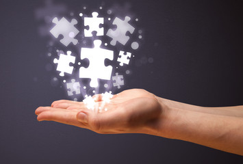 Puzzle pieces in the hand of a businessman