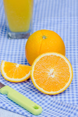 Oranges cut set and orange juice on table