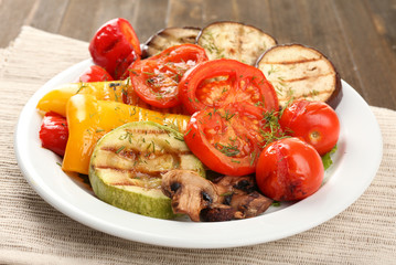 Delicious grilled vegetables on plate on table close-up