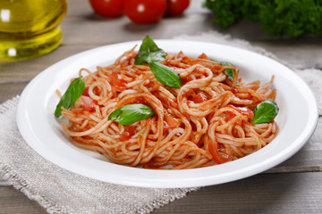 Pasta with tomato sauce on plate on table close-up