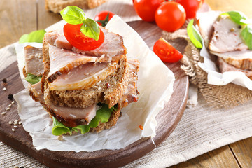 Delicious sandwiches with meet on table close-up