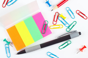 Pen, pencil, paperclips, pushpins and multicolored stickers