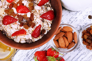 Healthy cereal with milk and strawberry on wooden table