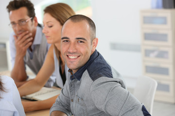 Smiling young businessman attending business training
