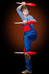 Clown playing with bowling pins