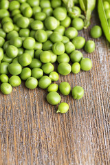 Fresh green peas on wooden background