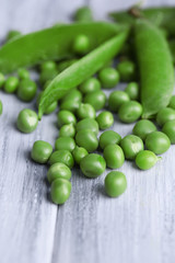 Fresh green peas on wooden background