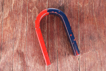 Magnet on color wooden background