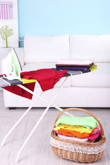 Basket with laundry and ironing board