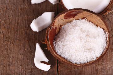 Broken coconut on wooden background