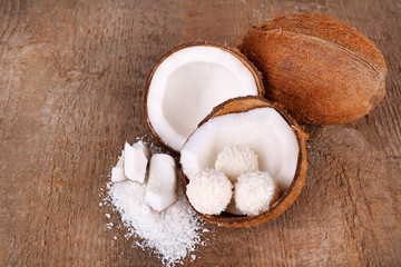 Broken coconut on wooden background