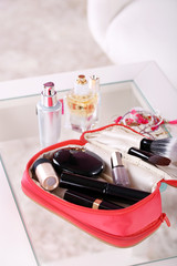 Cosmetic bag on table on light background