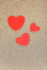 Hearts made of felt on golden background