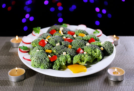 Christmas tree from broccoli on table on dark background