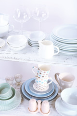 Different tableware on shelf, isolated on white