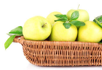 Ripe sweet apples with leaves in wicker basket, isolated