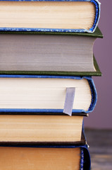 Stack of colorful hardback and paperback books, close-up,