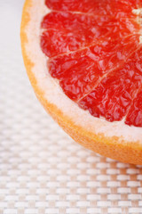 Half of grapefruit on light background