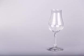 Empty glass for rum on white background