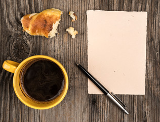 Coffee croissant and notepads